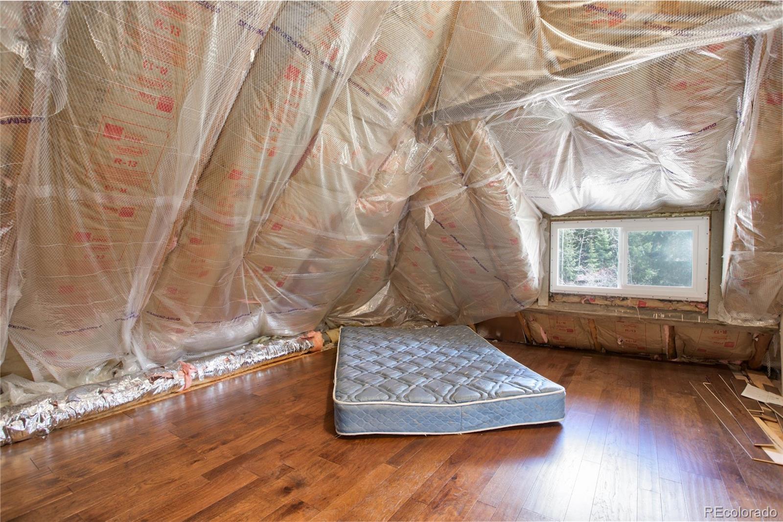 9399 Granzella Road Morrison, CO 80465 - Photo 25 of 41 a living room with hard wood floors and a rug