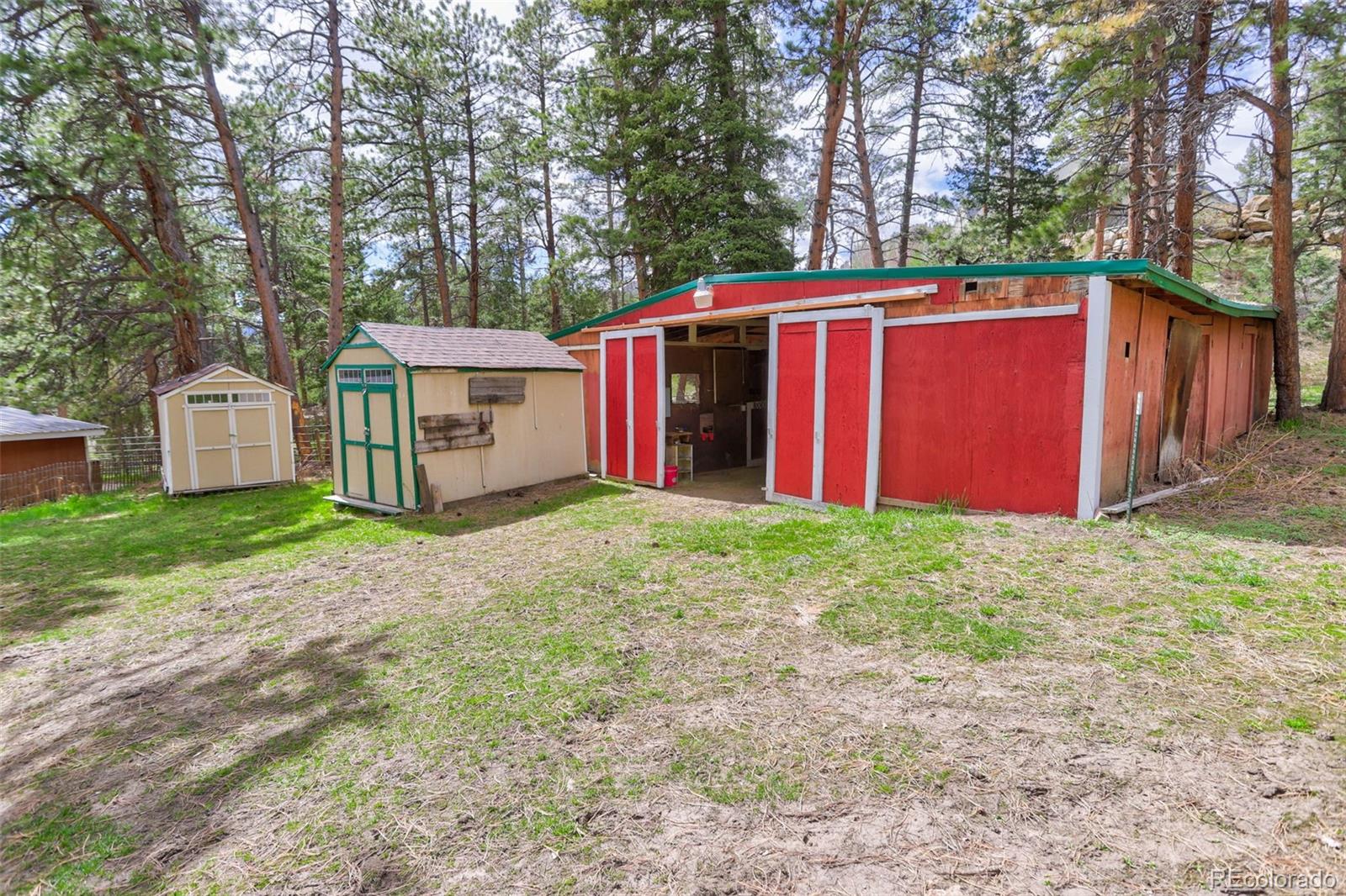 9399 Granzella Road Morrison, CO 80465 - Photo 29 of 41 a view of a barn in the middle of a yard