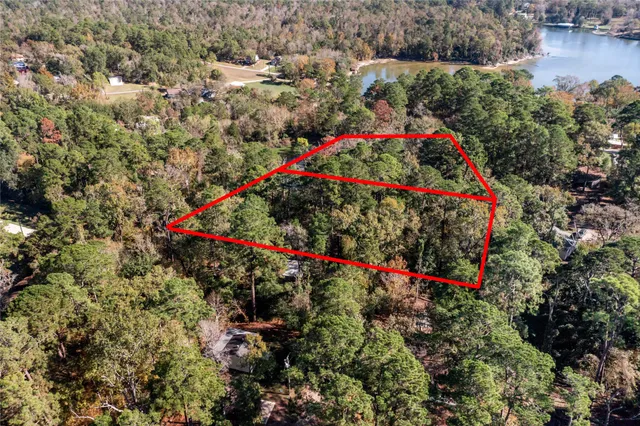 a view of a field with trees in the background