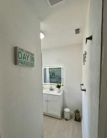 a bathroom with a sink a toilet and mirror