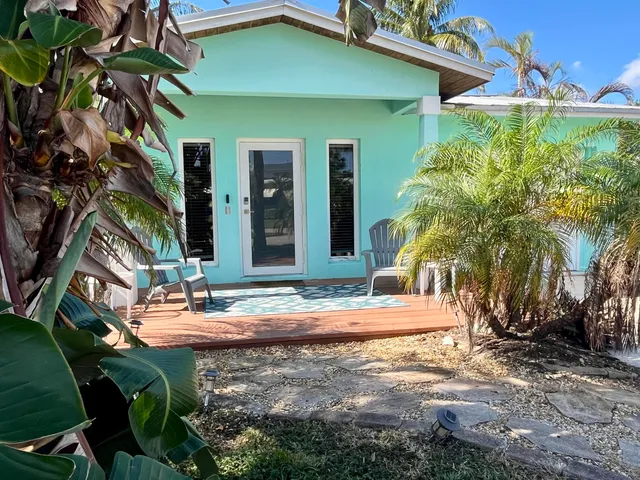 a backyard of a house with outdoor seating