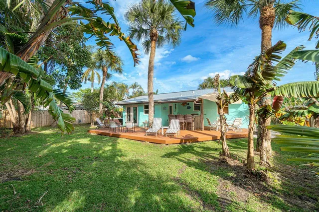 a view of a house with a backyard porch and sitting area