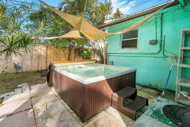 a view of backyard with swimming pool and outdoor seating