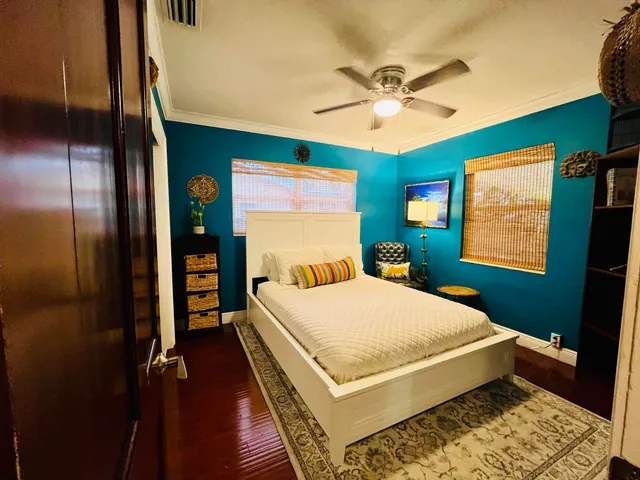 a bed sitting in a bedroom next to a window