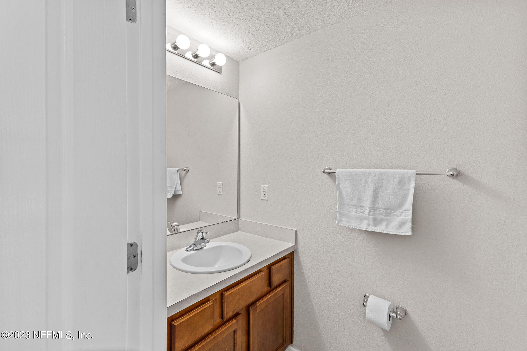 595 Servia Drive St. Johns, FL 32259 - Photo 11 of 56 a bathroom with a sink a mirror and a shower