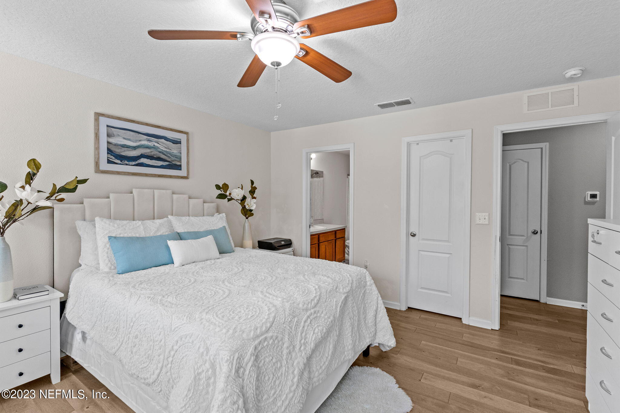 595 Servia Drive St. Johns, FL 32259 - Photo 19 of 56 a bedroom with a bed and a chandelier