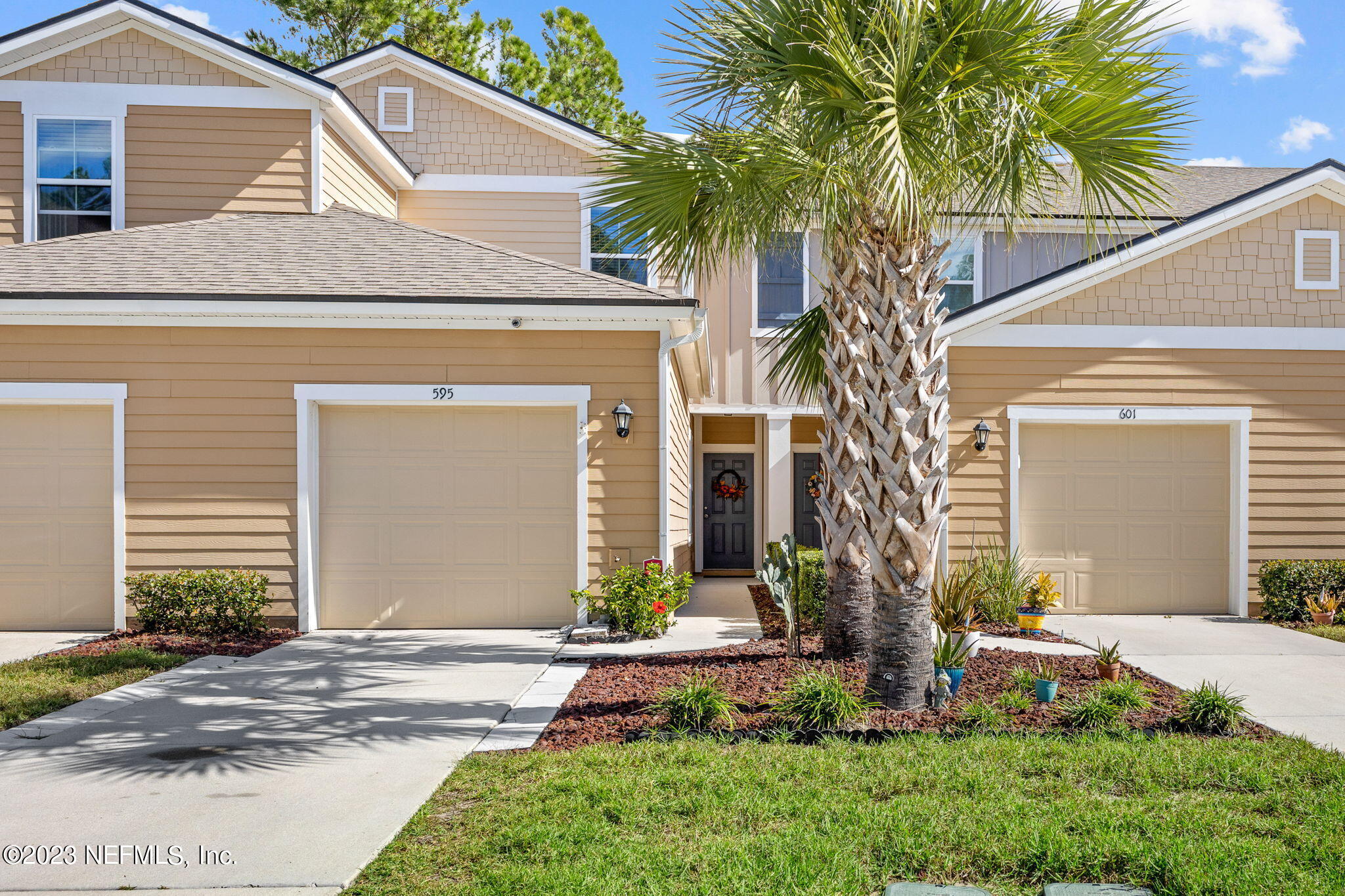 595 Servia Drive St. Johns, FL 32259 - Photo 5 of 56 a front view of a house with a yard garage and outdoor seating