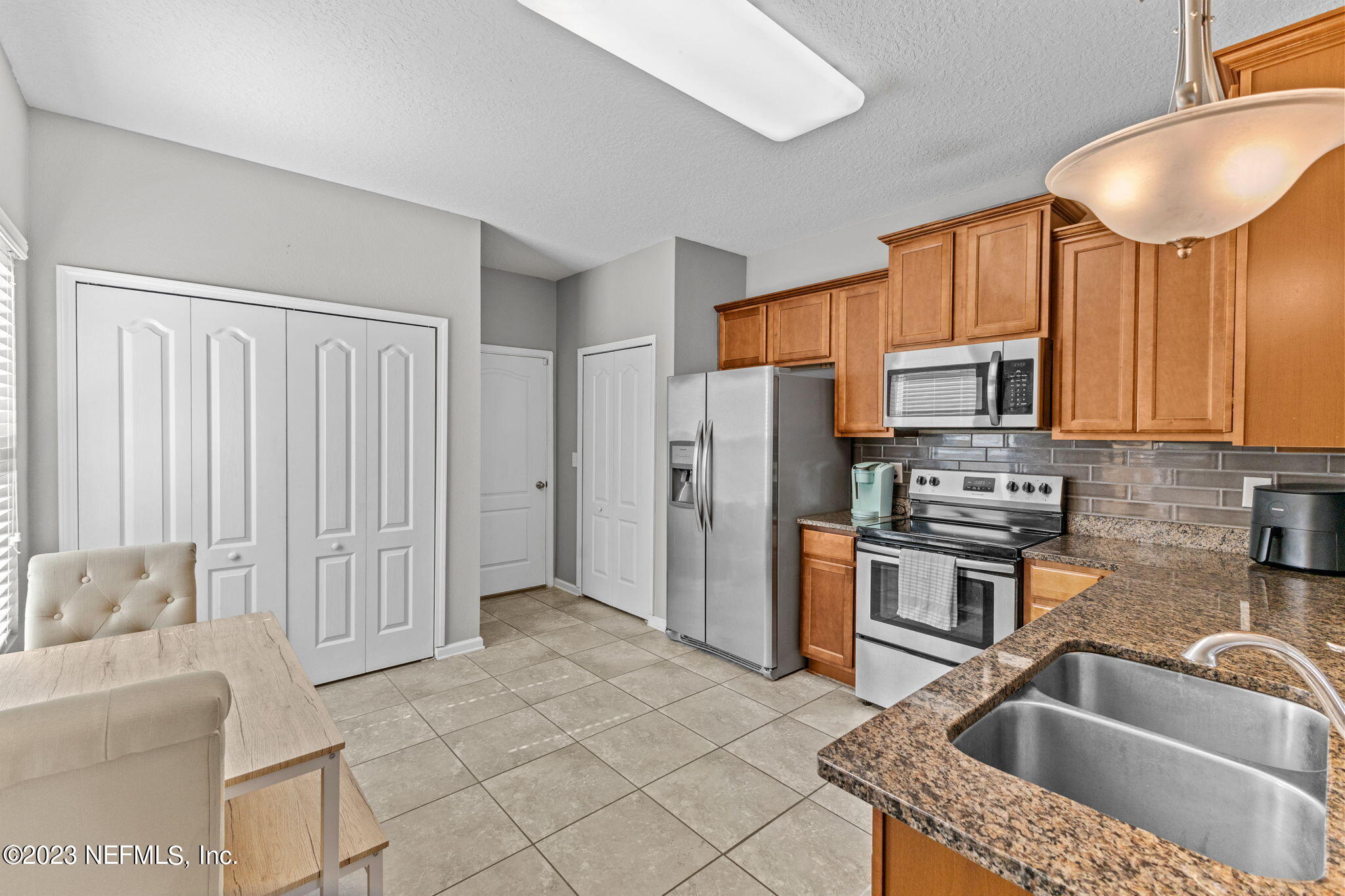 595 Servia Drive St. Johns, FL 32259 - Photo 9 of 56 a kitchen with stainless steel appliances granite countertop a sink refrigerator and cabinets