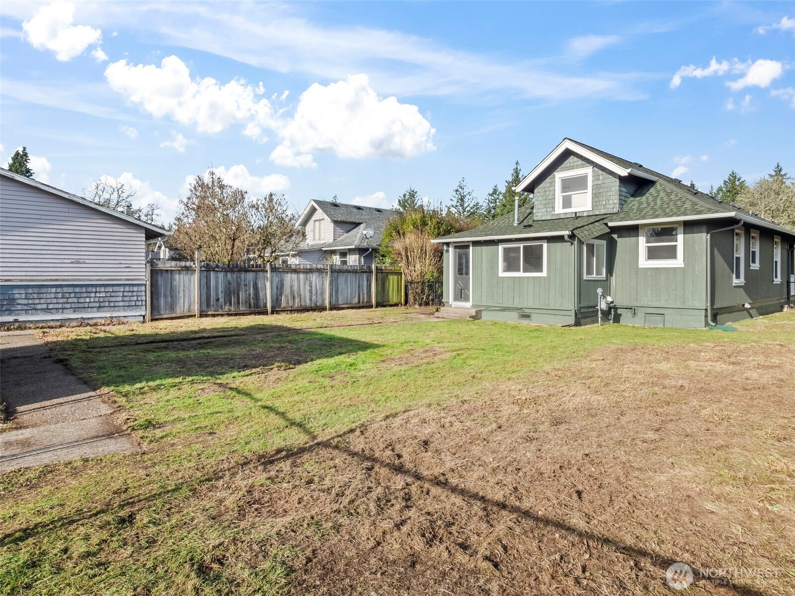 504 Dupont Avenue DuPont, WA 98327 - Photo 34 of 39 a view of a house with a big yard and large trees