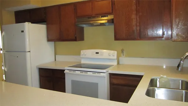 a kitchen with stainless steel appliances a stove a microwave and a refrigerator