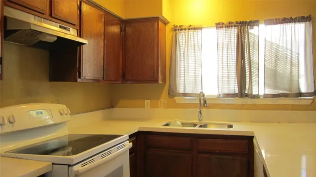 a kitchen with a sink and a window