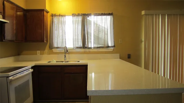 a kitchen with a sink and a window