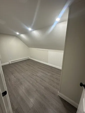 an empty room with wooden floor