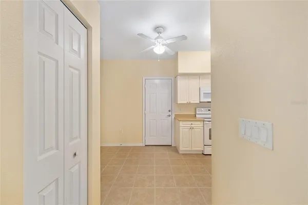 a kitchen with stainless steel appliances granite countertop a refrigerator and white cabinets