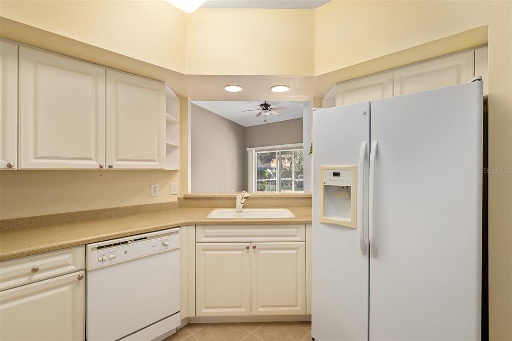5427 Compass Point, Unit 1 Oxford, FL 34484 - Photo 18 of 51 a kitchen with white cabinets and white appliances