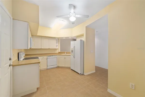 a view of a room with a ceiling fan and a window