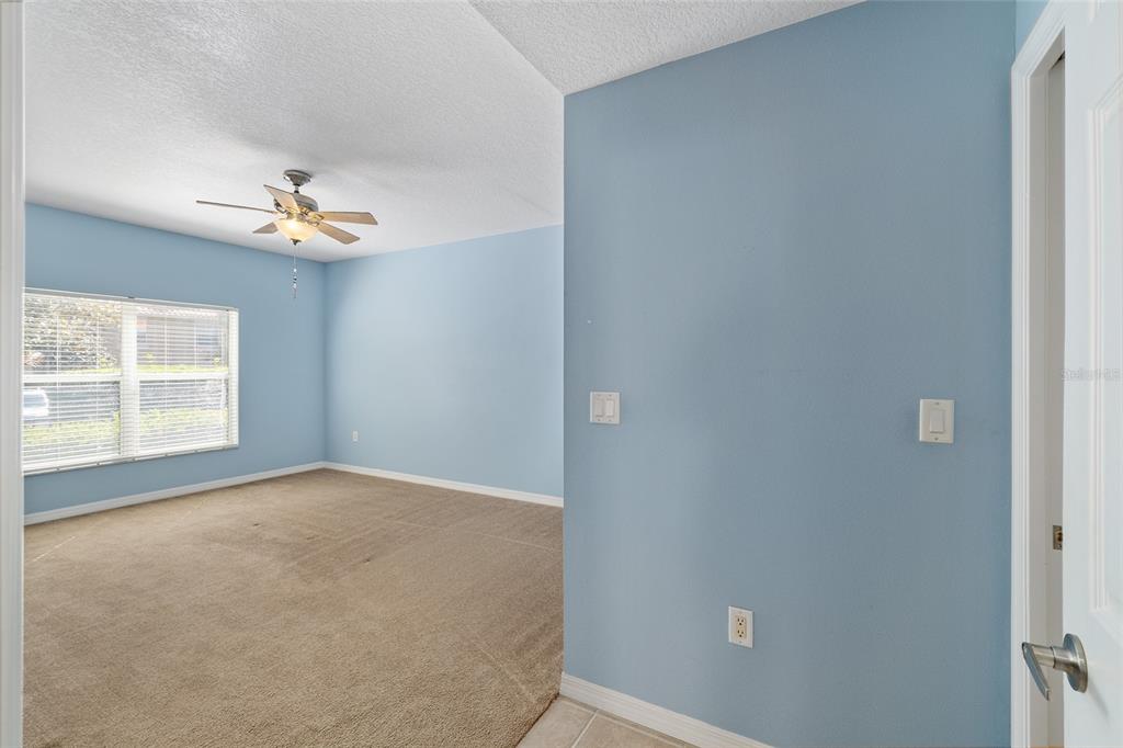5427 Compass Point, Unit 1 Oxford, FL 34484 - Photo 21 of 51 a view of a room with a ceiling fan and a window