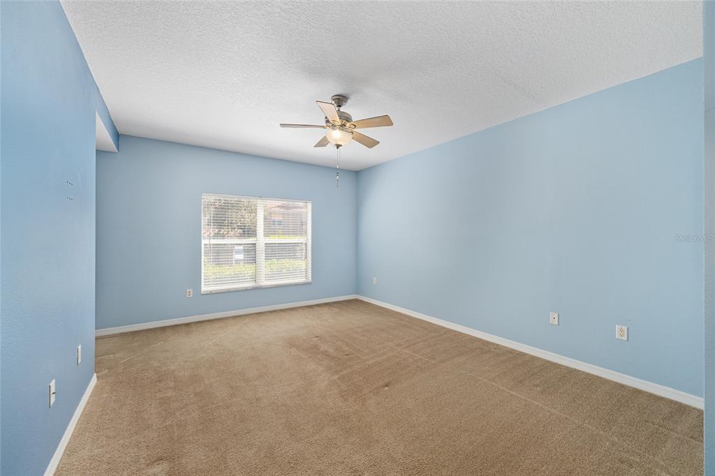5427 Compass Point, Unit 1 Oxford, FL 34484 - Photo 22 of 51 an empty room with chandelier fan and windows