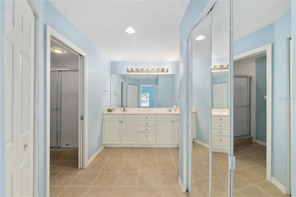 a spacious bathroom with a granite countertop sink and a mirror
