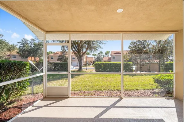 a view of a room with a large window and wooden floor