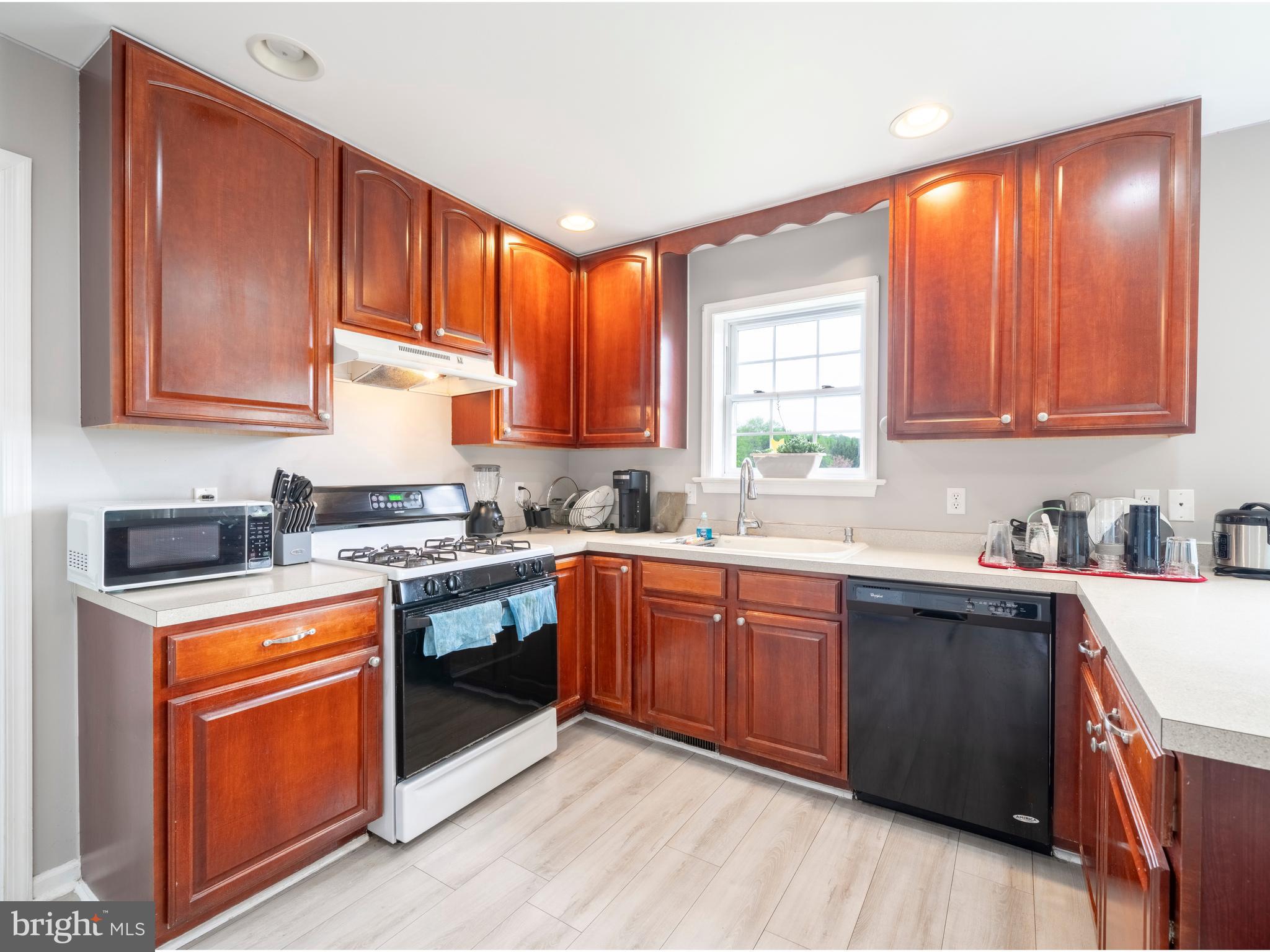 745 Apple Tree Lane Mount Wolf, PA 17347 - Photo 12 of 39 a kitchen with stainless steel appliances granite countertop wooden cabinets a sink dishwasher a stove and a refrigerator with wooden cabinets