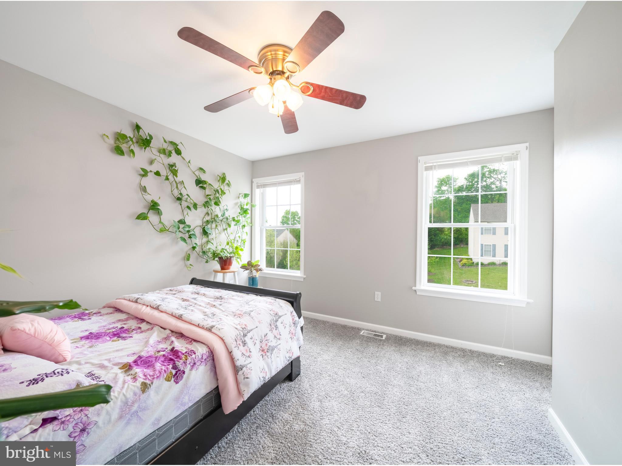 745 Apple Tree Lane Mount Wolf, PA 17347 - Photo 18 of 39 a bedroom with a large bed and a chandelier