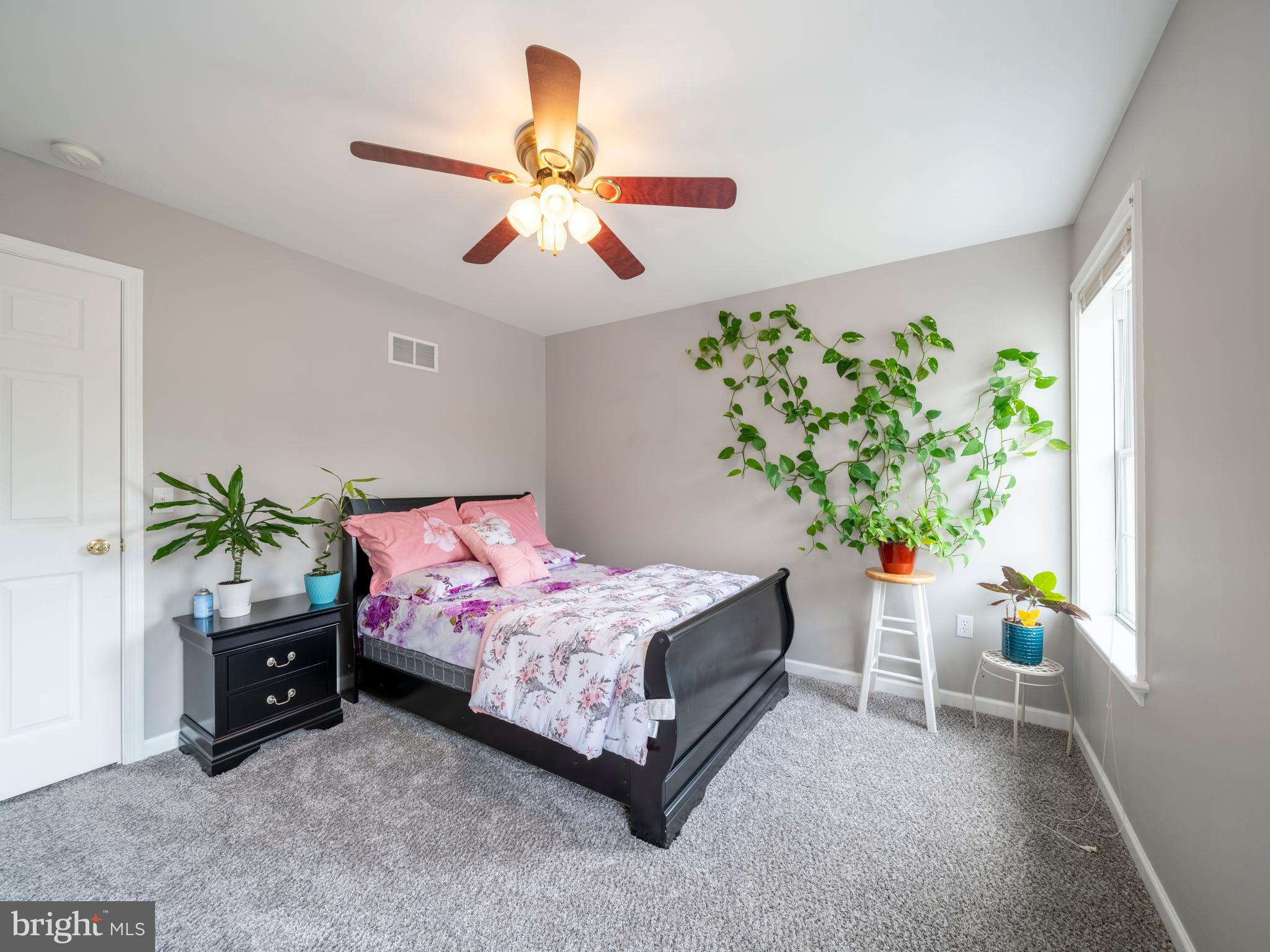 745 Apple Tree Lane Mount Wolf, PA 17347 - Photo 19 of 39 a bedroom with a bed and a potted plant