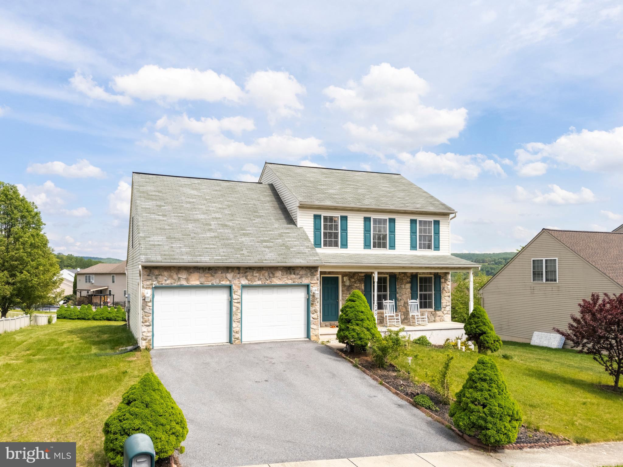 745 Apple Tree Lane Mount Wolf, PA 17347 - Photo 2 of 39 a front view of a house with a yard and garage