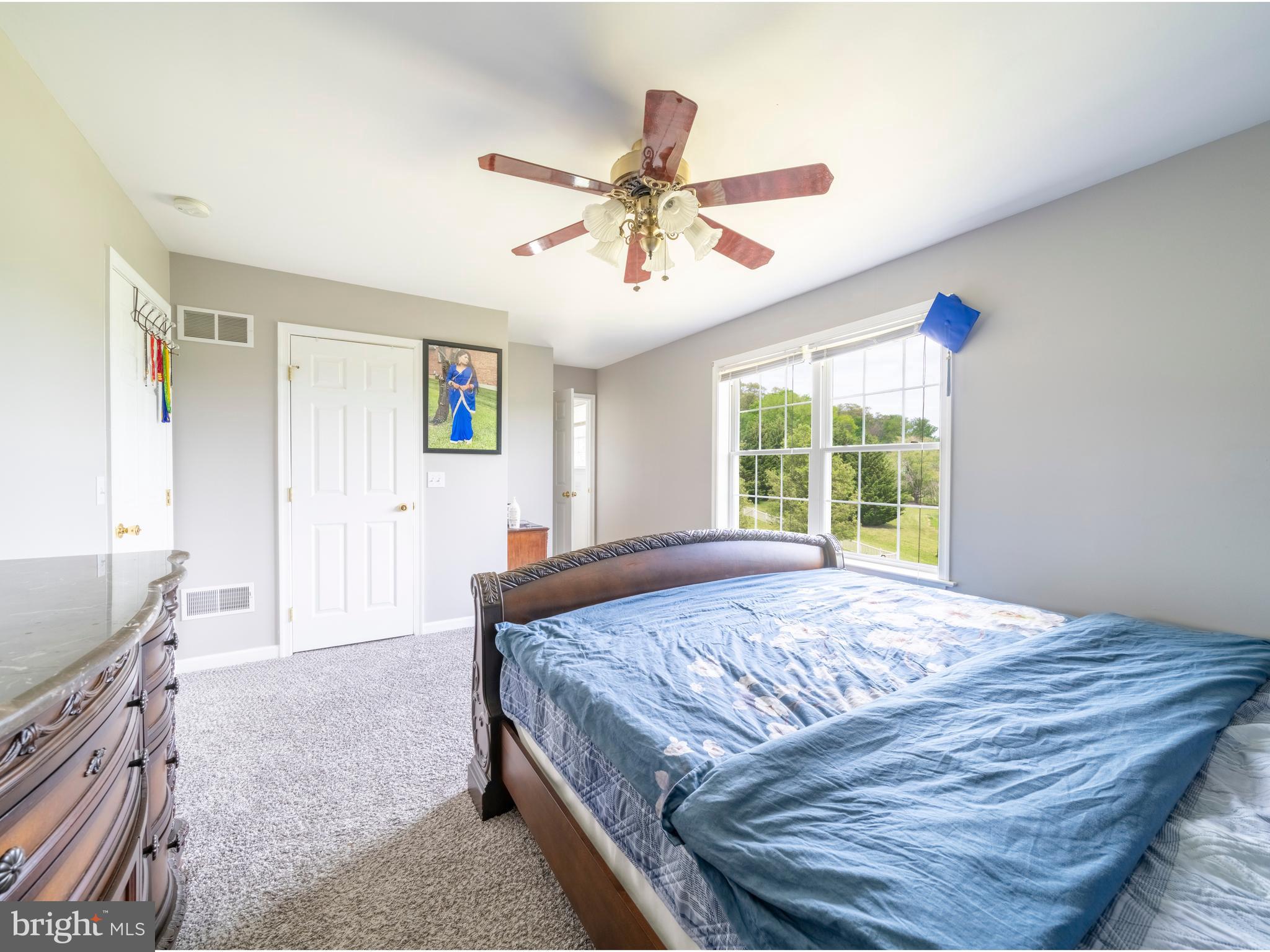 745 Apple Tree Lane Mount Wolf, PA 17347 - Photo 22 of 39 a bedroom with a bed dresser and a window