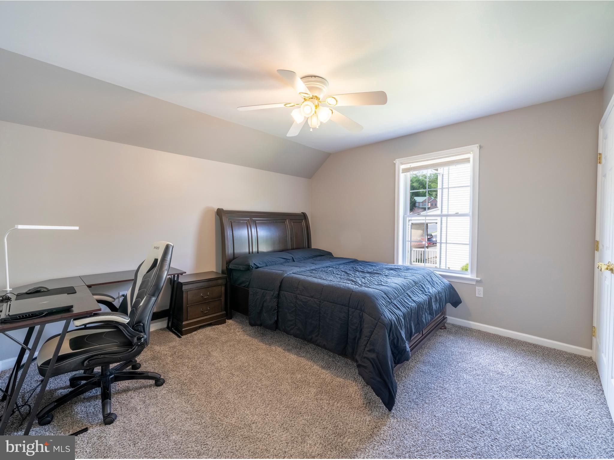 745 Apple Tree Lane Mount Wolf, PA 17347 - Photo 24 of 39 a bedroom with a bed table chair and a window