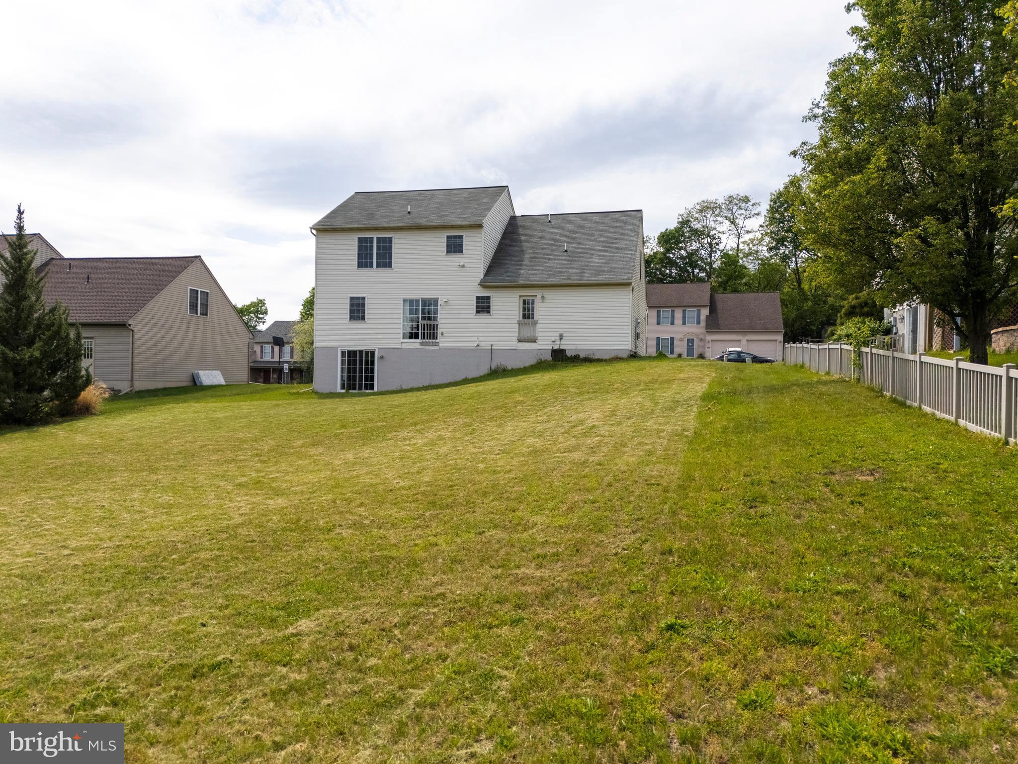 745 Apple Tree Lane Mount Wolf, PA 17347 - Photo 38 of 39 a view of a house with a yard and a large tree