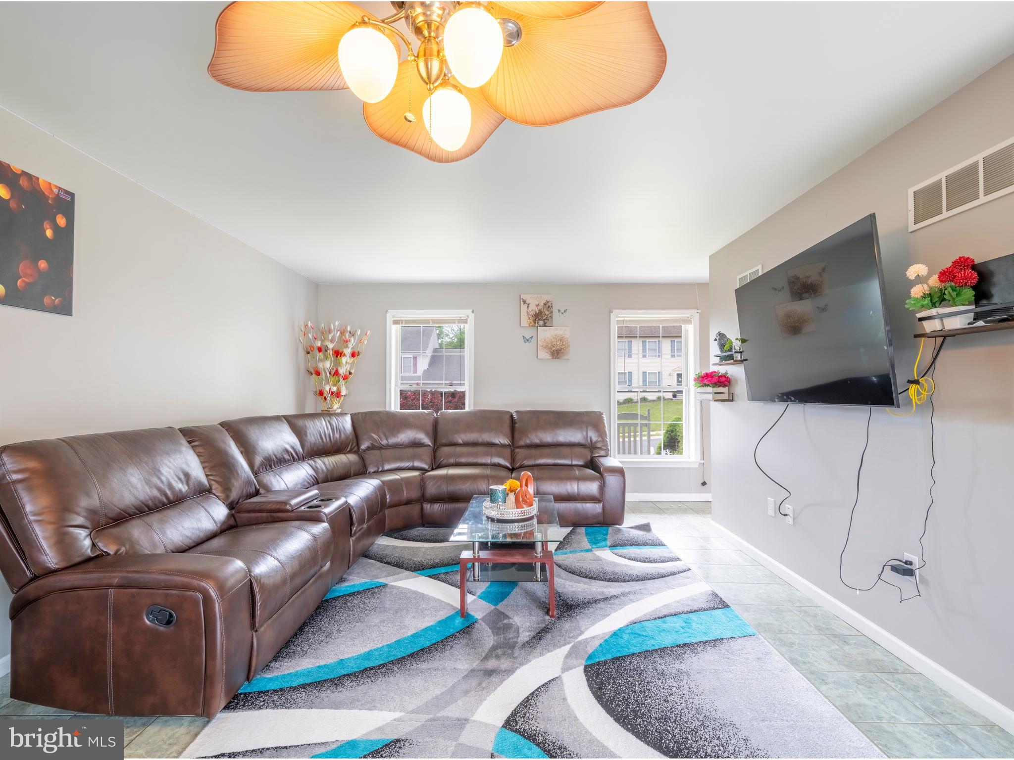 745 Apple Tree Lane Mount Wolf, PA 17347 - Photo 8 of 39 a living room with furniture and a flat screen tv