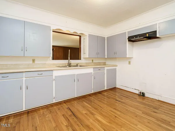 a room with a sink cabinets and utility room