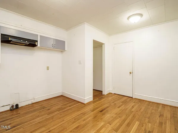 a view of a room with wooden floor