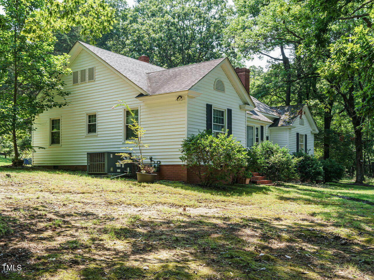 1191 Old Sanford Road Moncure, NC 27559 - Photo 3 of 30 a view of a house with yard and plants