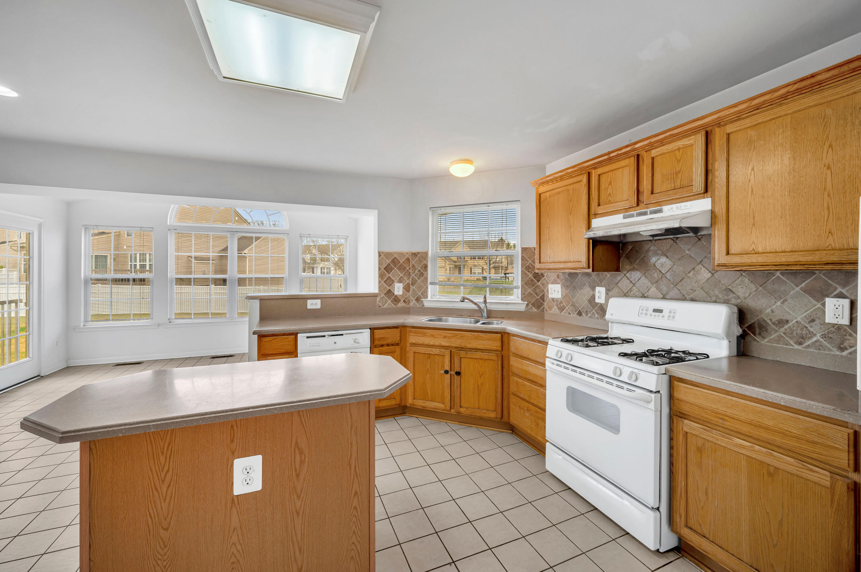 1179 Blair Road Bethlehem, PA 18017 - Photo 12 of 41 a kitchen with stainless steel appliances granite countertop a sink a stove and white cabinets