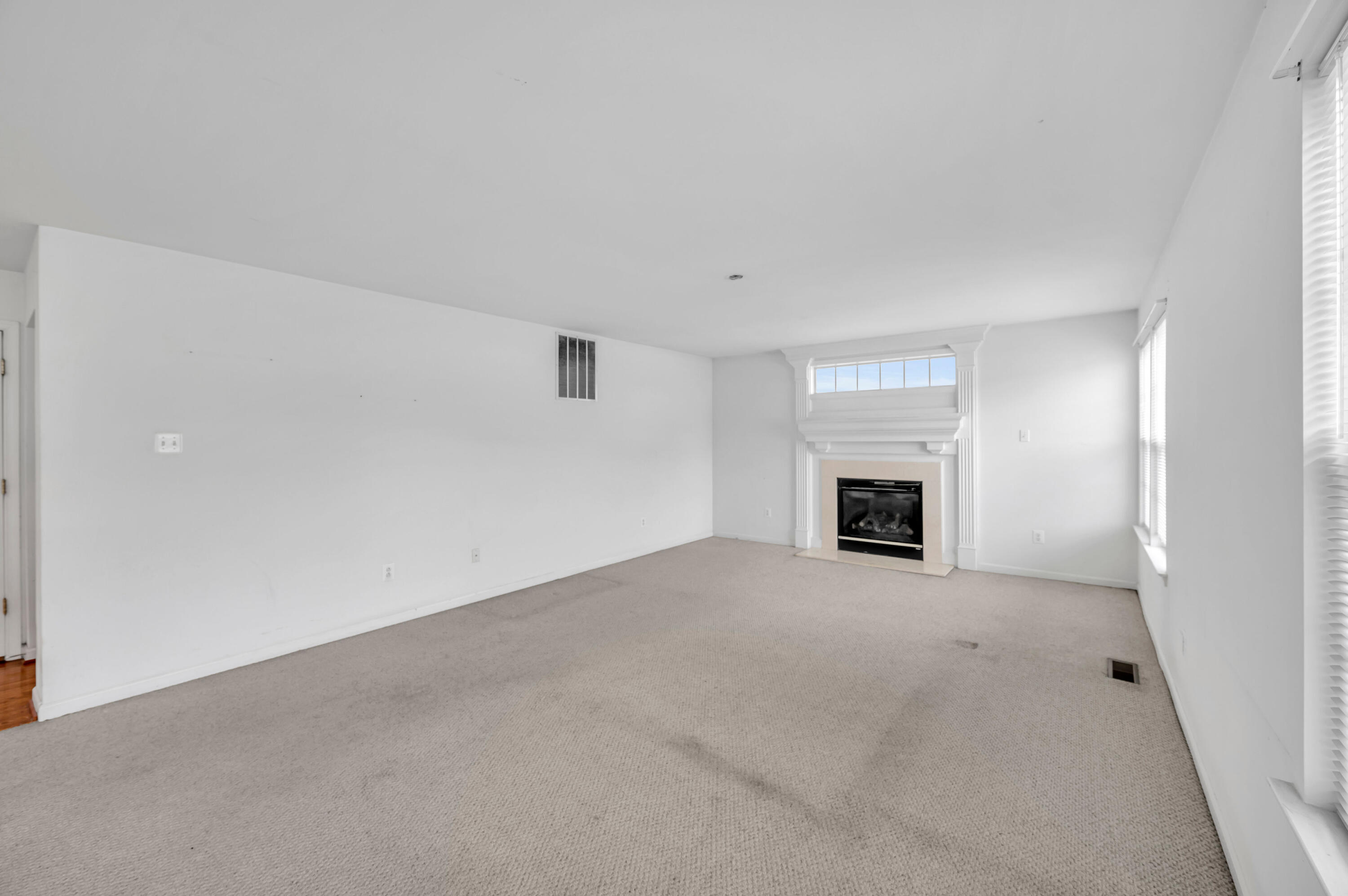 1179 Blair Road Bethlehem, PA 18017 - Photo 17 of 41 an empty room with fireplace and a window