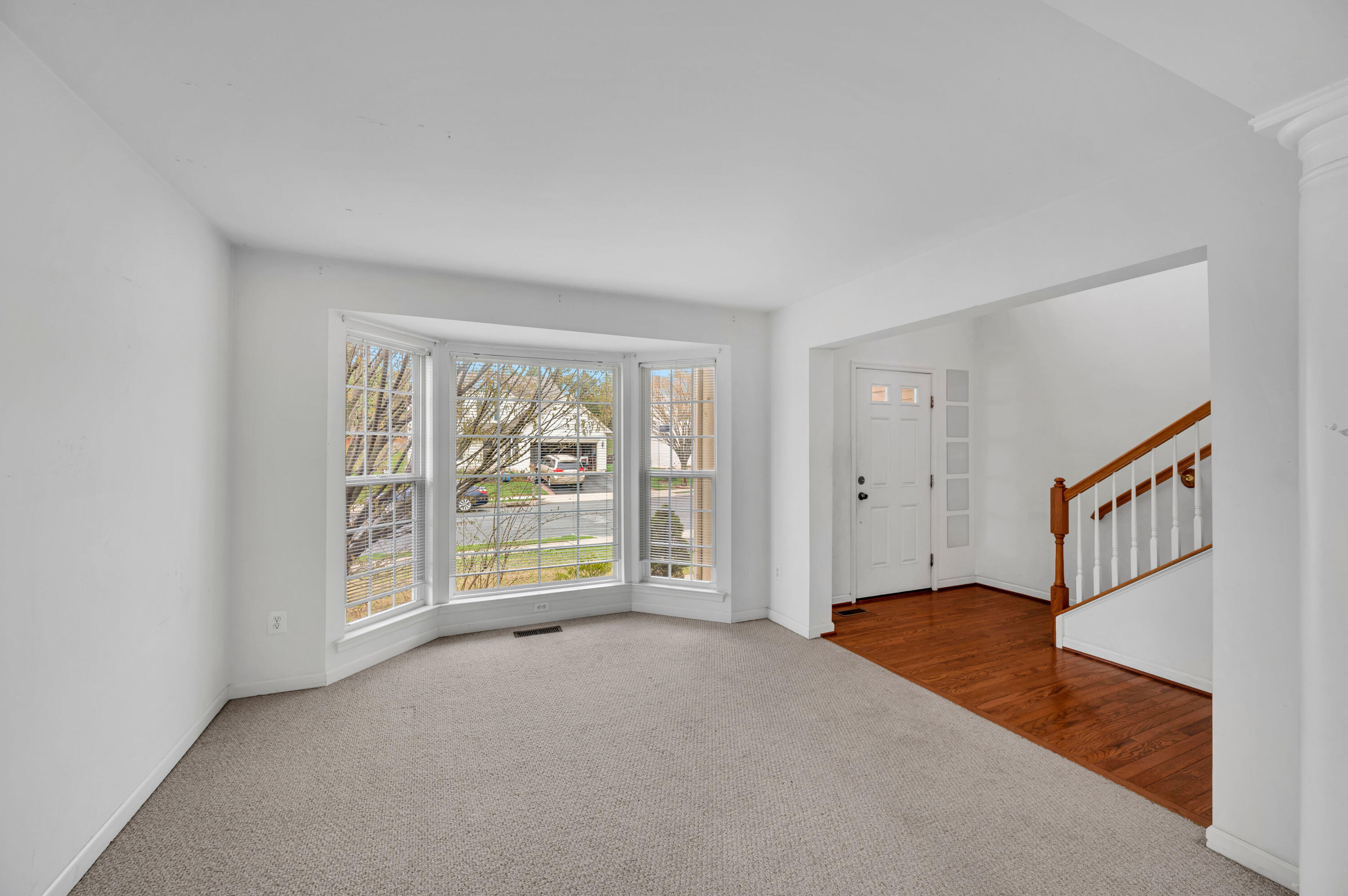 1179 Blair Road Bethlehem, PA 18017 - Photo 4 of 41 an empty room with floor to ceiling windows and a chandelier