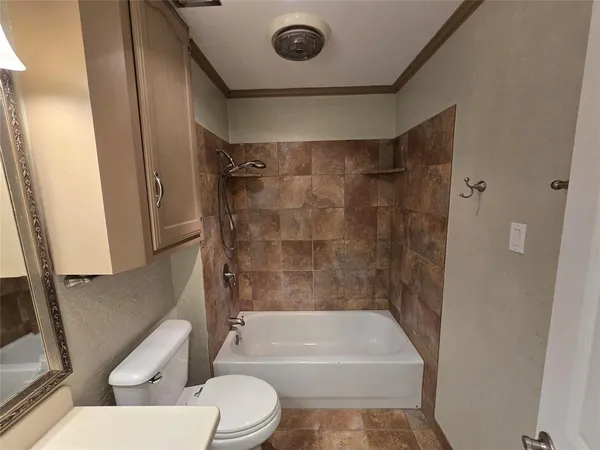 a bathroom with a toilet a sink and bathtub