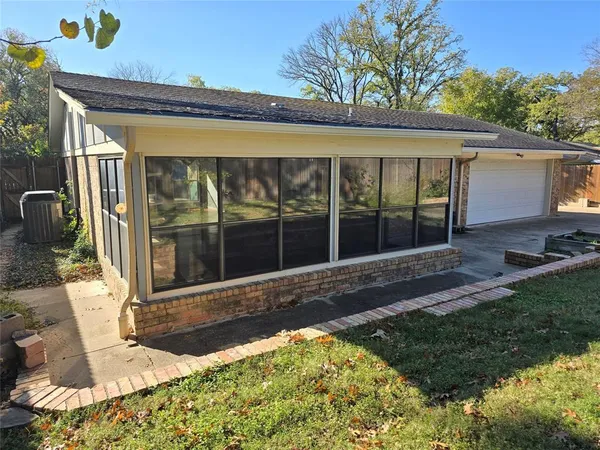 a view of a house with backyard porch and sitting area