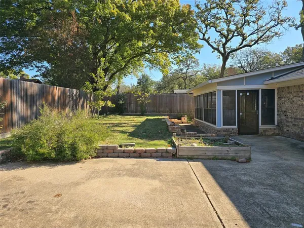 a view of a house with backyard and sitting area