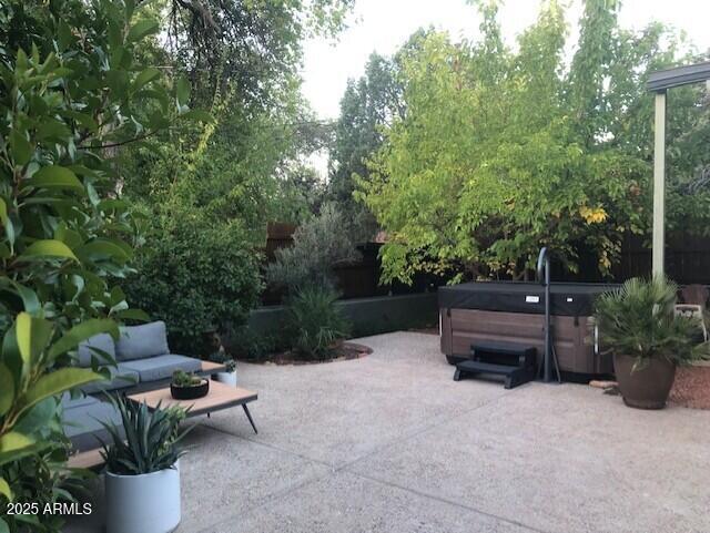 325 Smith Road Sedona, AZ 86336 - Photo 9 of 11 a wooden bench sitting in the middle of a garden
