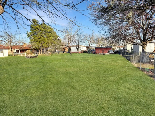 a view of a park with large trees