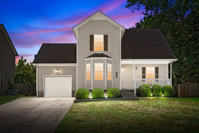 a front view of a house with a yard and garage