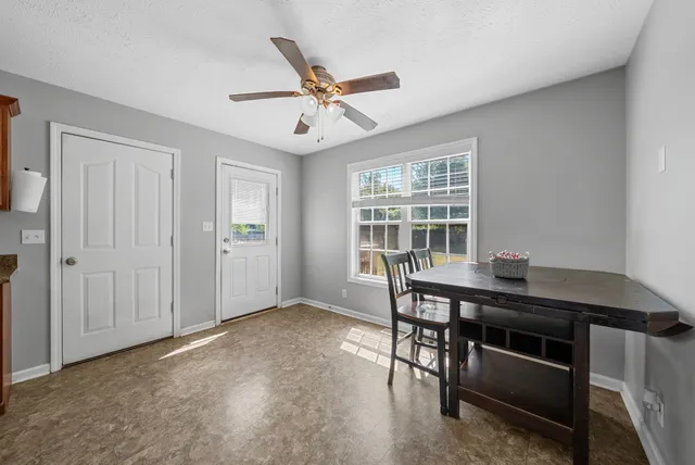 a view of a workspace with furniture and window