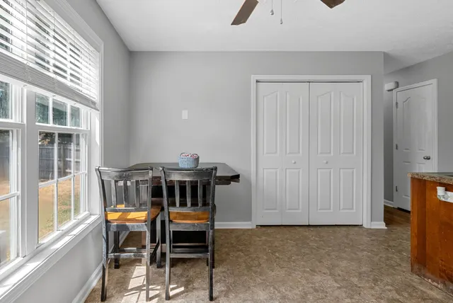 a view of a dining room with furniture and window