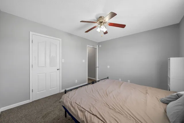 a bedroom with a large bed and a chandelier