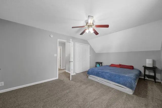 a living room with furniture and a ceiling fan