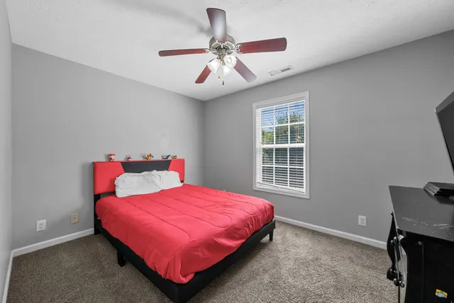 a bedroom with a bed and a chandelier