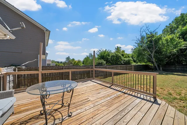 a view of balcony with wooden floor and outdoor seating